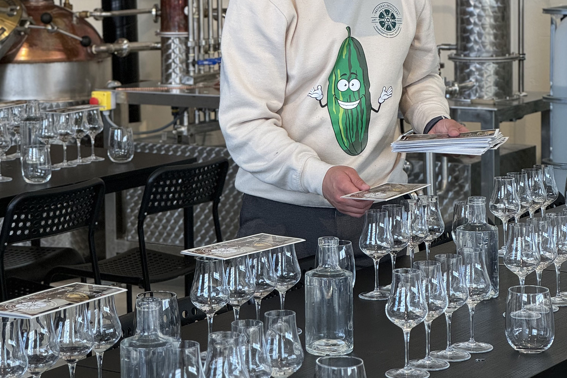 Man som förbereder en ginprovning med glas och informationsblad. Man som förbereder en ginprovning med glas och informationsblad.