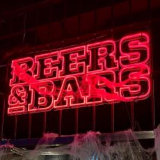 Beers & Bars logga lyser i röd neon.