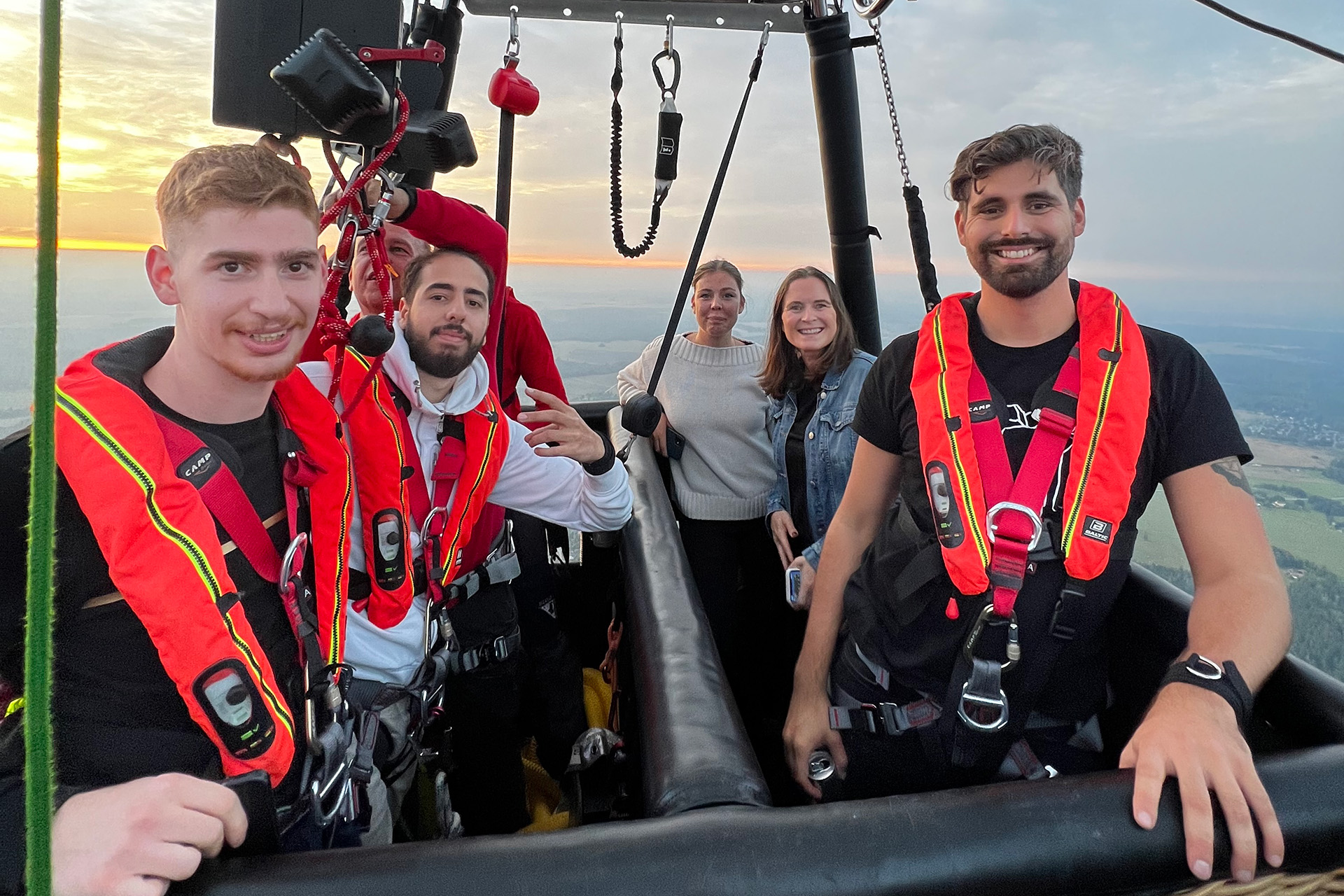 Flera personer står redo i sele för att hoppa bungyjump från en luftballong.